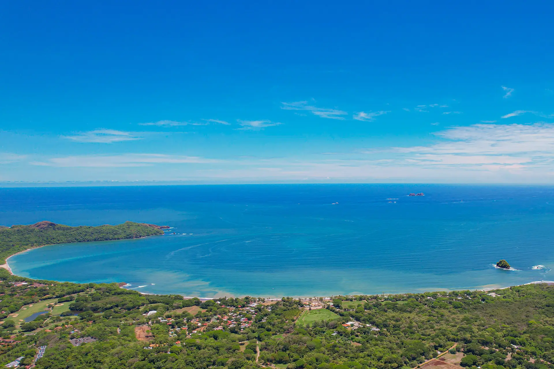 Aerial view over the Gold Coast shoreline and green hills
