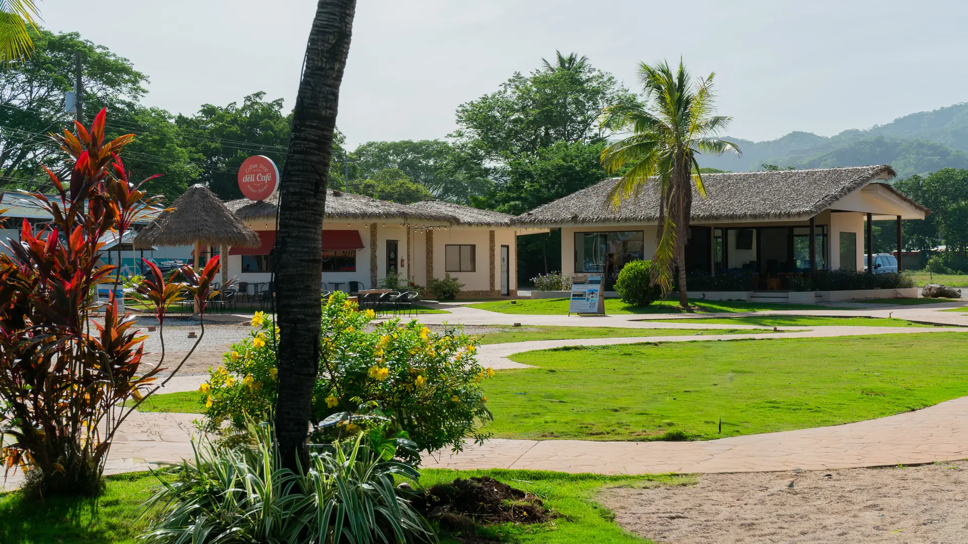 Tropical gardens and single-story villas near the beach